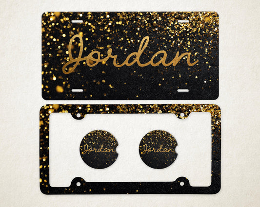 May include: A black license plate and car coaster set with gold glitter and the name "Jordan" in gold script. The license plate has a black background with gold glitter. The car coasters have the name "Jordan" in gold script.